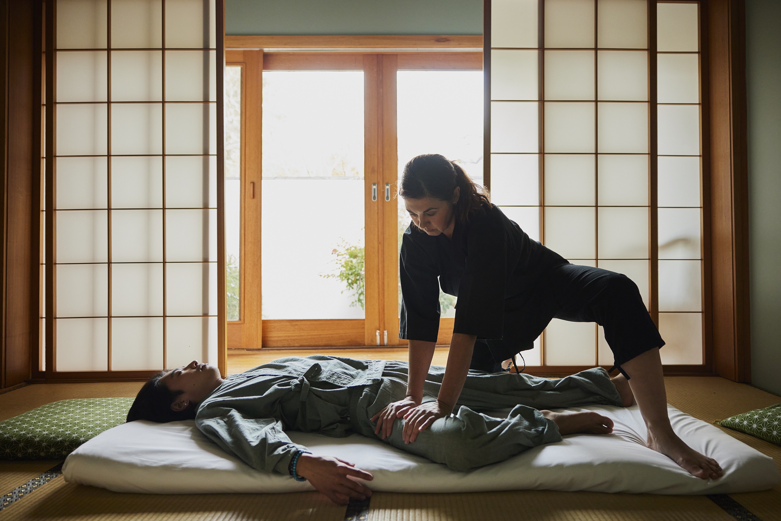 Therapist doing a shiatsu massage for a guest